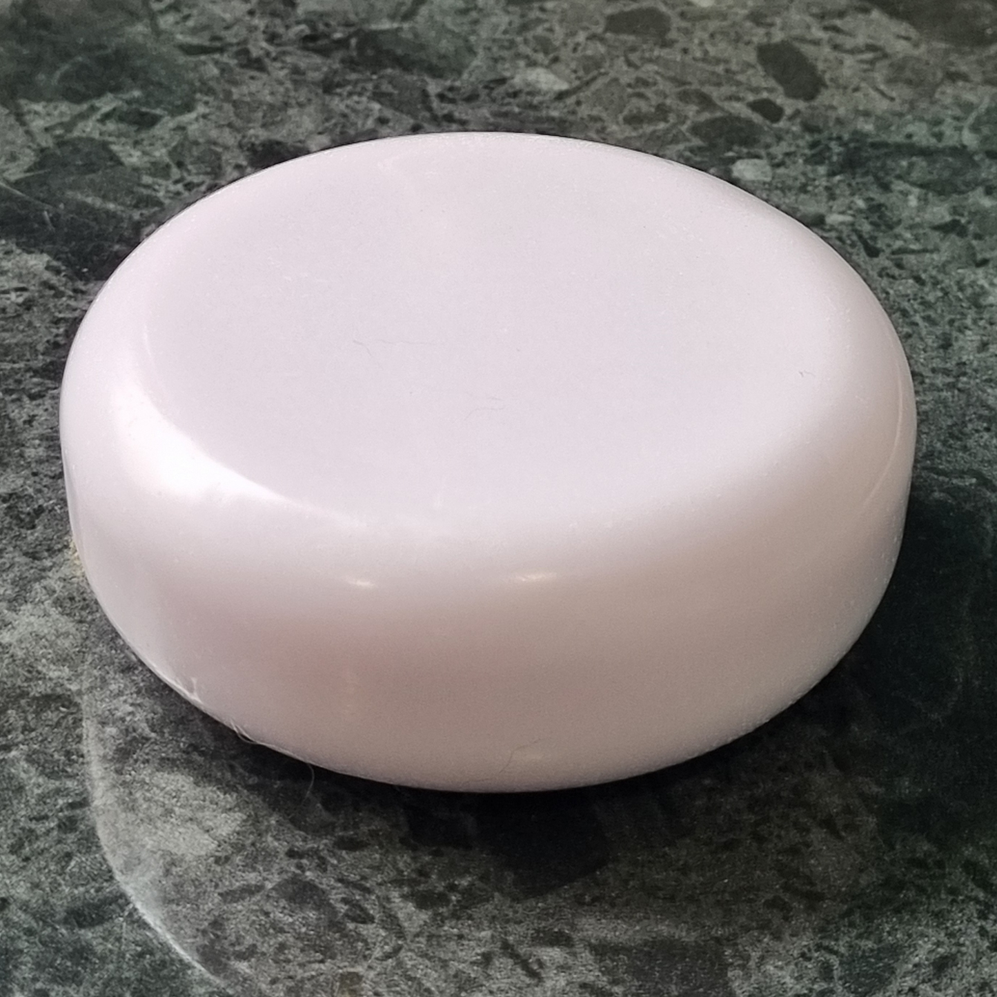 Round lavender goat milk soap with pale purple tint