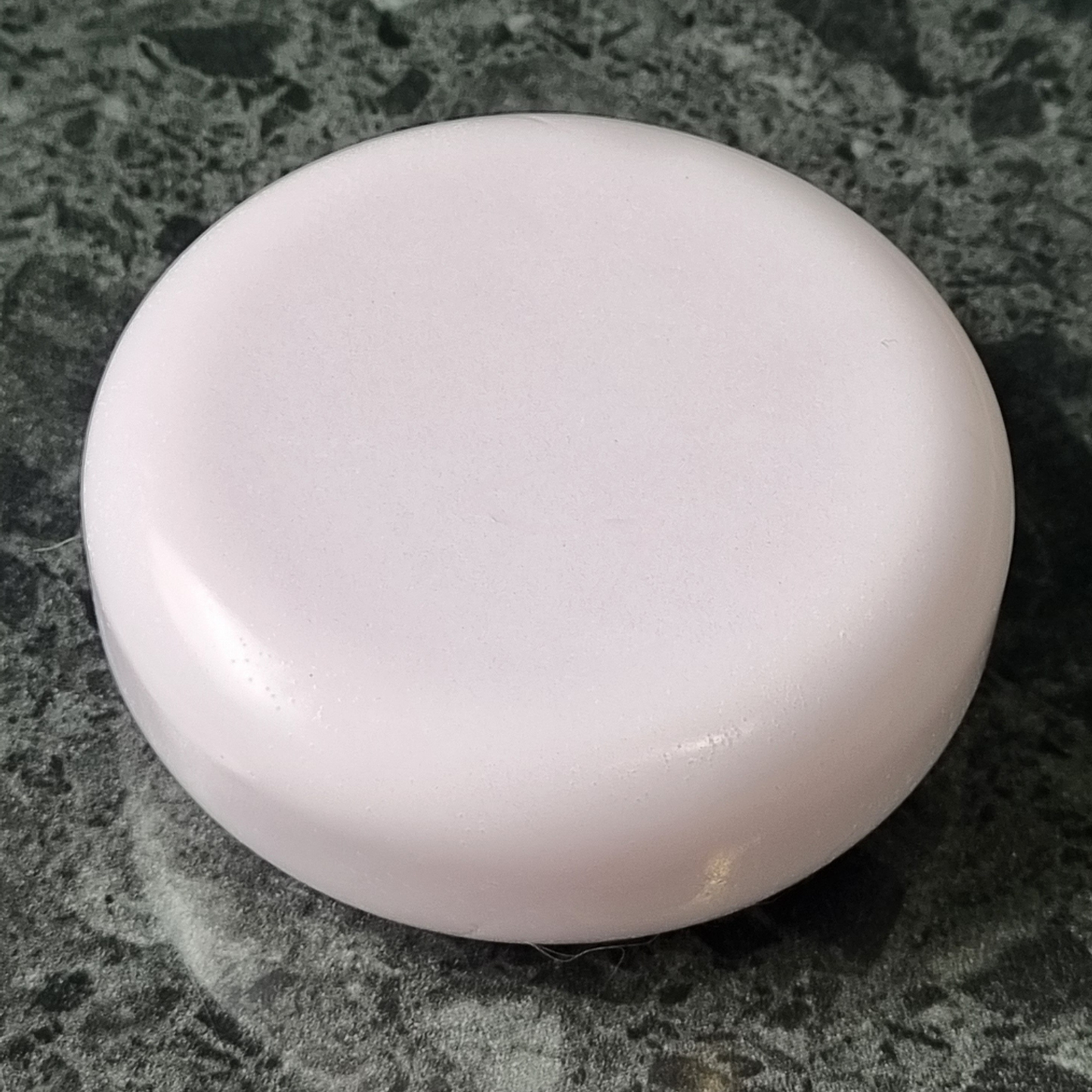 Lavender scented round soap on stone background